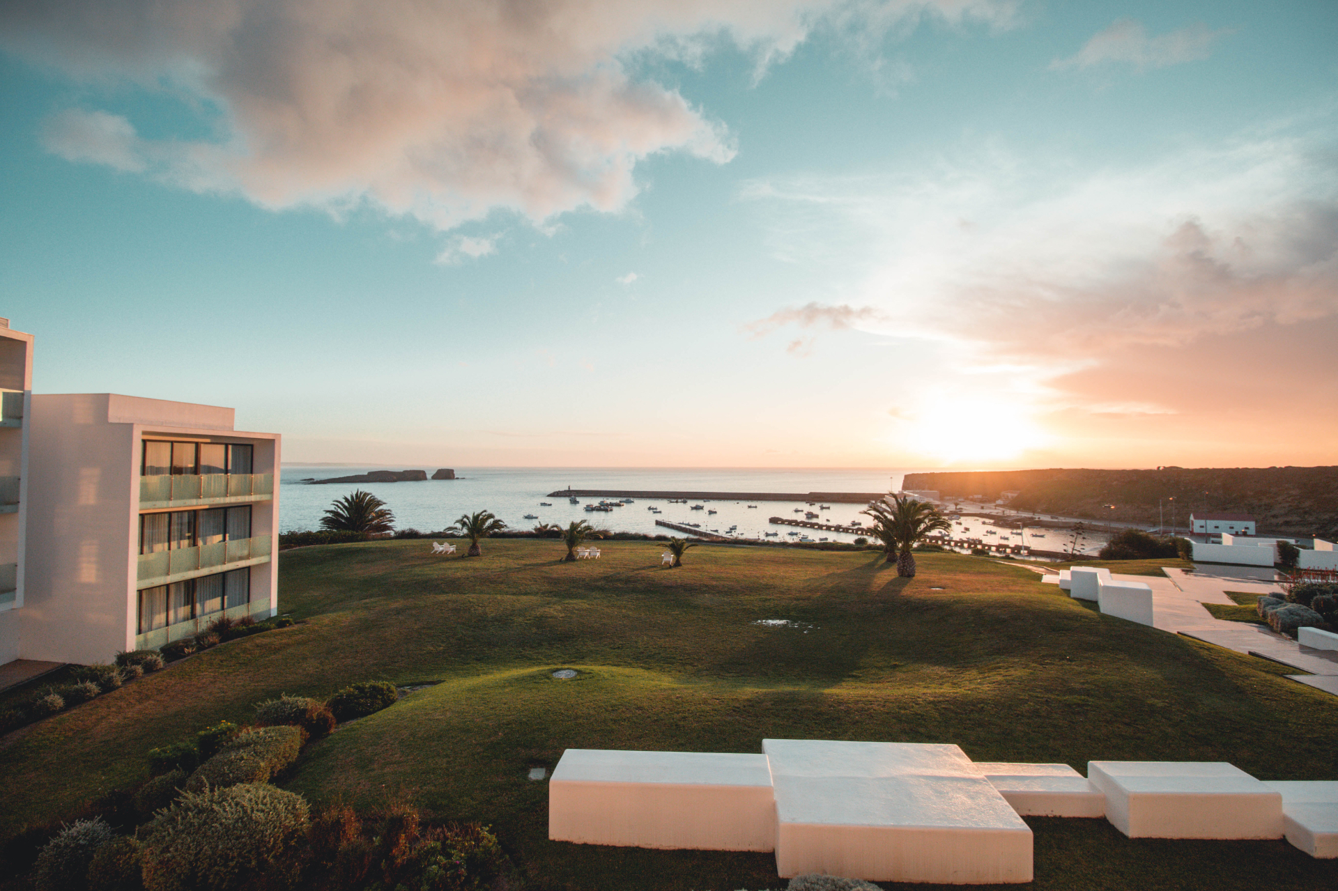 Sunset over the lawn and Sagres harbour from Memmo Baleeira Hotel