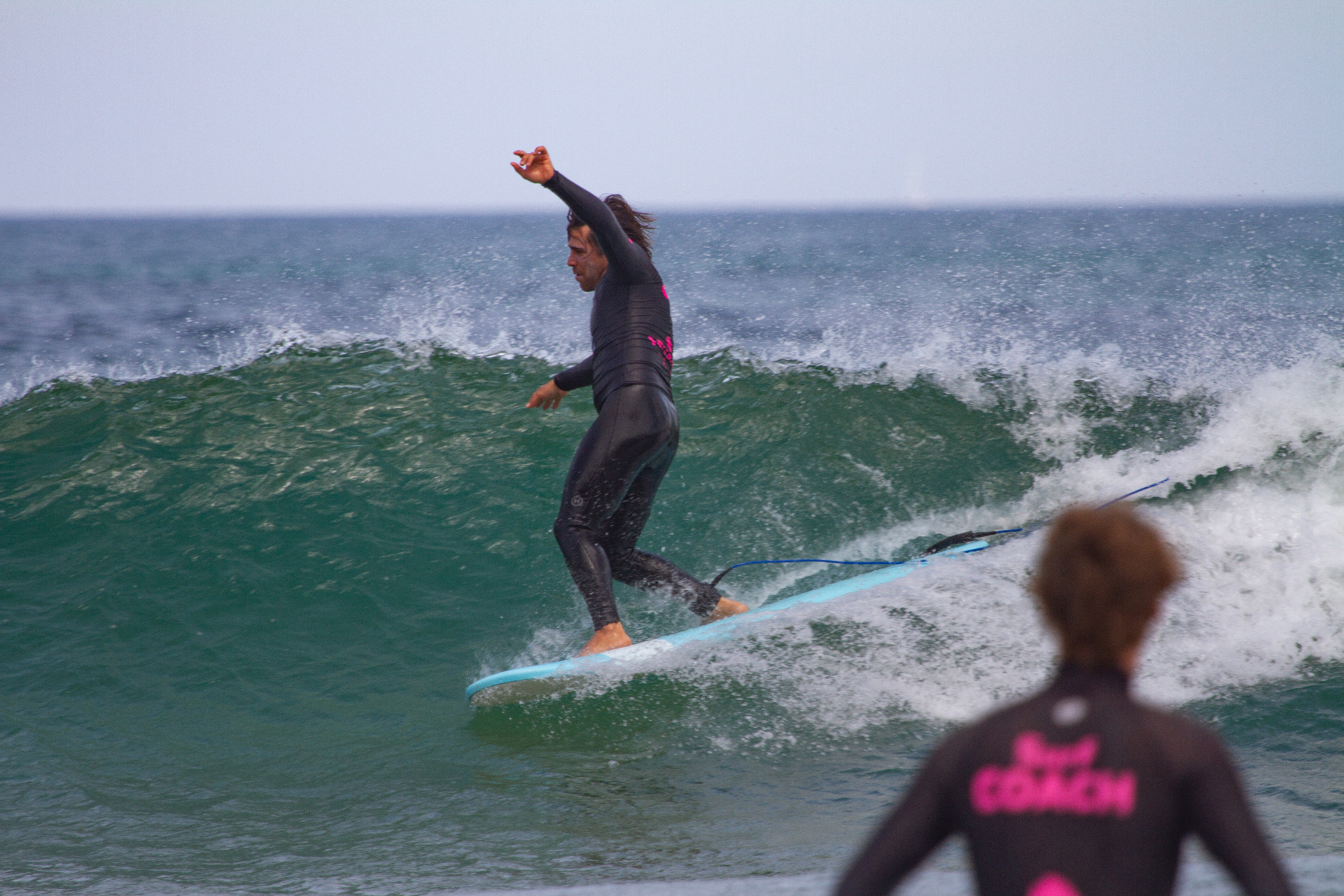 Surfer dropping into a clean wave at Praia da Cordoama, Sagres