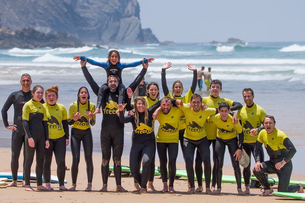 Family enjoying a surf lesson together on the beach in Sagres, Algarve